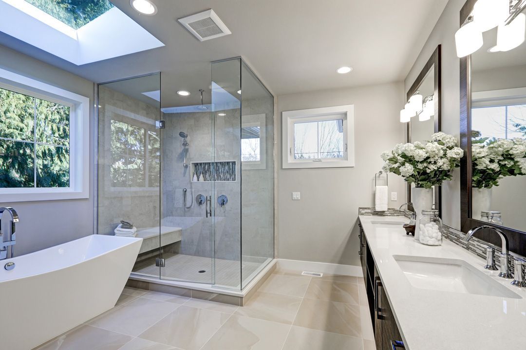 Ansicht eines modernen, hellen Badezimmers mit Glasdusche und Glasspiegel